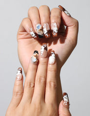 Close-up of Amber Bloom handmade Singapore press on nails with rhinestones and floral details