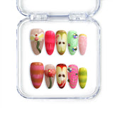 Medium almond Singapore press on nails in red and green with apple slices, a 3D worm, and cute cottagecore details by Naillover.