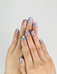 Model wearing Aqua Flash Singapore press on nails with glossy blue, ribbon, and summer design