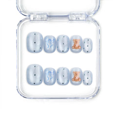 Aqua Flash Singapore press on nails with blue base, ribbon accents, and bear patterns by naillover