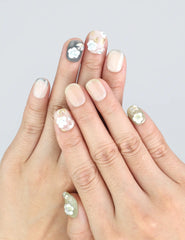 Hand gesture featuring handmade press on nails with 3D white florals, olive base, and soft French fade by Naillover