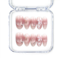 Blush Blossom Sparkle Singapore press on nails with soft translucent pink base, white floral patterns, and metallic accents, handmade by naillover for a trendy and elegant look.