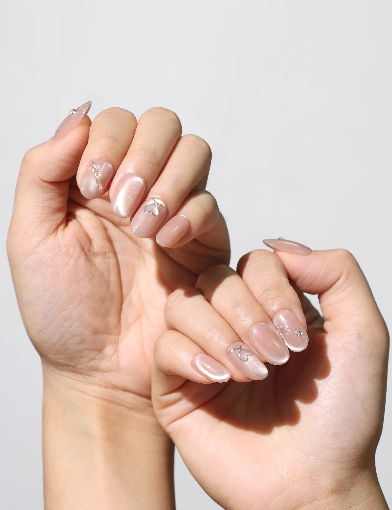 Blush Gleam Cat Eye Singapore press on nails worn for chic everyday style, handmade by naillover with silver cat eye finish.