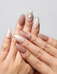 Hand wearing Blush Pearl Gleam Singapore press on nails in brown gradient with silver glitter – naillover