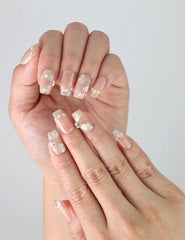 Close-up of Butterfly Grace handmade press on nails in pink and white gradient with holographic butterfly art