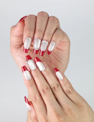 Close-up of Naillover’s handmade red coffin nails with bold silver glitter gradient and glossy finish