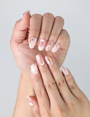 Close-up of Naillover’s handmade press-on nails in pastel pink featuring 3D flowers, glossy pearl accents, and subtle shimmer