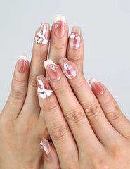 Hand wearing Cherry Bow Crush handmade press on nails with pink gingham and 3D bows from naillover Singapore collection