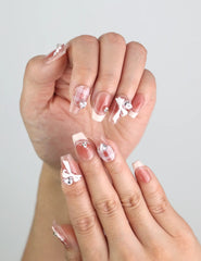 Close-up of Cherry Bow Crush handmade press on nails with rhinestone accents and soft pink hues from naillover Singapore press on nails