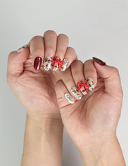 Model showcasing Crimson Bow handmade press on nails Singapore style, adding holiday cheer to a chic outfit