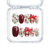 Crimson Bow handmade Singapore press on nails in red with white bows and festive confetti accents by naillover, perfect for Christmas parties and celebrations