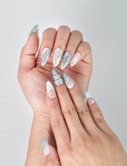 Close-up of Naillover’s handmade Singapore nails featuring cool blue tones, glossy sheen, and gem-like embellishments