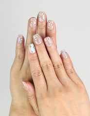 Hand wearing Crystal Dust nude short Singapore press on nails with shimmering finish, classic style by naillover
