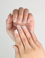 Close-up of Crystal Dust nude short handmade press on nails with gem details for elegant everyday wear