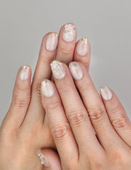 Hand wearing Naillover Crystal Sparkle handmade press on nails with iridescent cat eye finish and colorful specks.