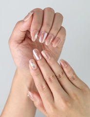 Close-up hand pose highlighting romantic pastel pink press on nails with a delicate luminous sheen, crafted by Naillover