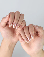Fingers elegantly displayed with Naillover’s handmade short nails in a dreamy morning glow pink hue