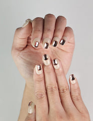 Close-up of Dream Glitter Singapore press-on nails with pink rhinestones on beige base, cute nails by naillover