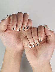 Elegant hand pose showcasing Dream Glitter handmade press-on nails, beige with pink rhinestones, Singapore