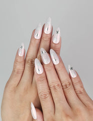 Model wearing Ethereal Stars light pink press-on nails with silver stars, handmade Singapore nails by naillover