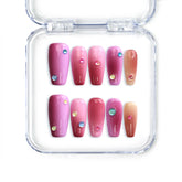 Handmade medium coffin Singapore press on nails with pink to red ombre and sparkling iridescent gems.