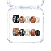 Naillover Floral Glow handmade Singapore press on nails with nude, brown, and black tones, floral art and pearl accents.