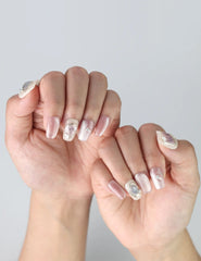 Close-up of pastel gradient press on nails with sparkling glitter and raised floral nail art from Naillover's Flower Glint design