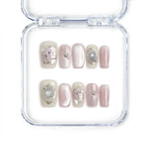 Close-up of Naillover Flower Glint handmade press on nails with pink-white glitter and 3D floral accents, styled in pastel gradients