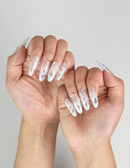 Close view of Frost White Singapore press-on nails on hand, with shimmering silver glitter accents, handmade by naillover