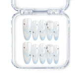 Close-up of Frost White Singapore press-on nails with silver glitter accents, handmade by naillover