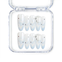 Close-up of Frost White Singapore press-on nails with silver glitter accents, handmade by naillover