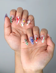 Side view of floral almond nails with pink and green pastel tones and fruity spring-themed designs