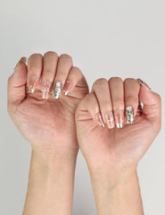 Close-up of model’s hand showing Glamorous nude Singapore press on nails with glitter details, handmade by Naillover