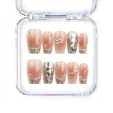 Close-up of Glamorous nude Singapore press on nails with gold sequins and glitter, handmade by Naillover for an elegant classic nails look