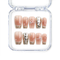 Close-up of Glamorous nude Singapore press on nails with gold sequins and glitter, handmade by Naillover for an elegant classic nails look