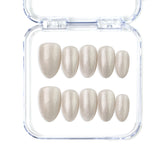 Naillover Glimmer Dust short almond handmade press on nails with golden shimmer and geometric accents, Singapore style.