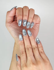 Close-up of Naillover Glinting Gray handmade cat eye nails on hand, sleek metallic grey finish, trendy press on nails SG