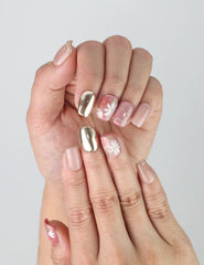 Close-up of Naillover’s handmade square nails in glossy red with 3D flowers and metallic gold foil detailing