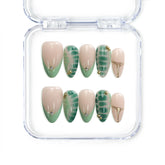 Naillover Singapore handmade short almond nails in nude and green tones with tropical leaf art and gold accents