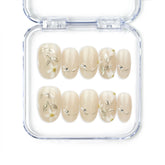 Ivory Bloom handmade press on nails with nude base, gold leaf, and white floral accents, designed by NailLover in Singapore.