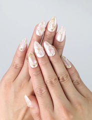 Hand gesture showing pastel pink press on nails with 3D floral art and gold details, handmade in Singapore by Naillover