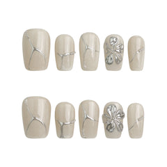 Product display of Naillover’s handmade ivory press-on nails with silver foil effect