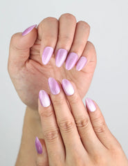 Close-up of Naillover’s Lilac Sparkle handmade press on nails in almond shape, shimmering lavender finish.