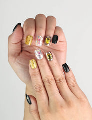 Close-up of Luxe Mix handmade Singapore press on nails with black, gold, glitter, and gem accents, naillover