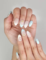 Close-up of Naillover Marine Dream Singapore press on nails, featuring pastel tones with shimmering accents and gold details.
