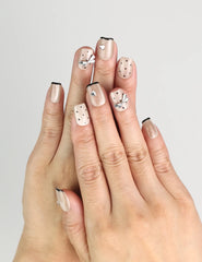 Hand wearing Naillover Midnight Bow handmade Singapore press on nails, beige-black with dots and silver ribbons