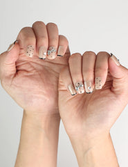 Side view of hand showcasing Naillover Midnight Bow handmade Singapore press on nails with playful dots and silver ribbons