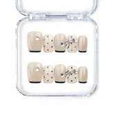 Naillover Midnight Bow handmade Singapore press on nails in beige and black with dots and metallic silver ribbons, short length