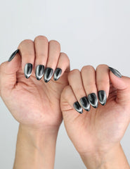 Midnight Gaze almond press on nails by Naillover, styled for a night-out look with subtle cat eye shine.