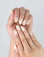 Close-up of Naillover’s handmade Singapore nails featuring neutral greige tones and luminous gold accents
